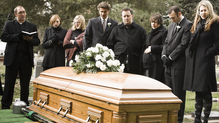 people at a funeral in a cemetery