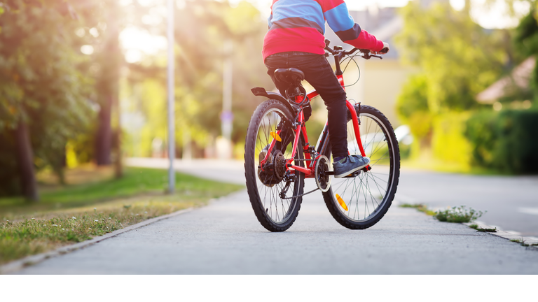 child on a bicycle in the evening