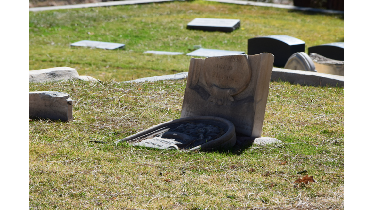 Broken Tombstones At Cemetery