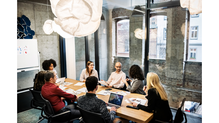 A group of young people in a business meeting.