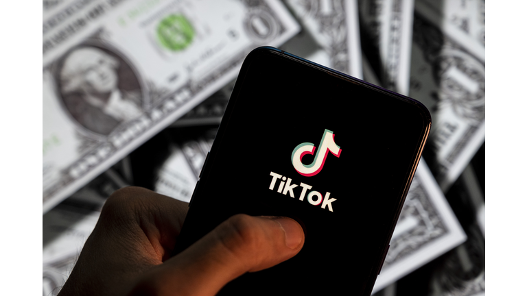 In this photo illustration, a TikTok logo seen displayed on