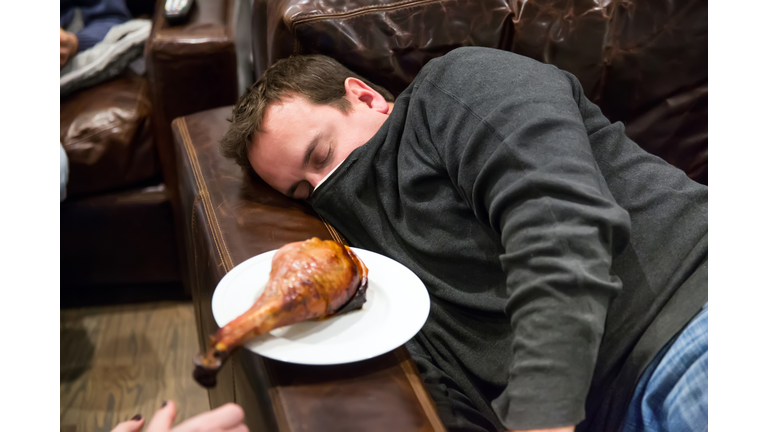 Caucasian man takes nap in a comfortable leather chair