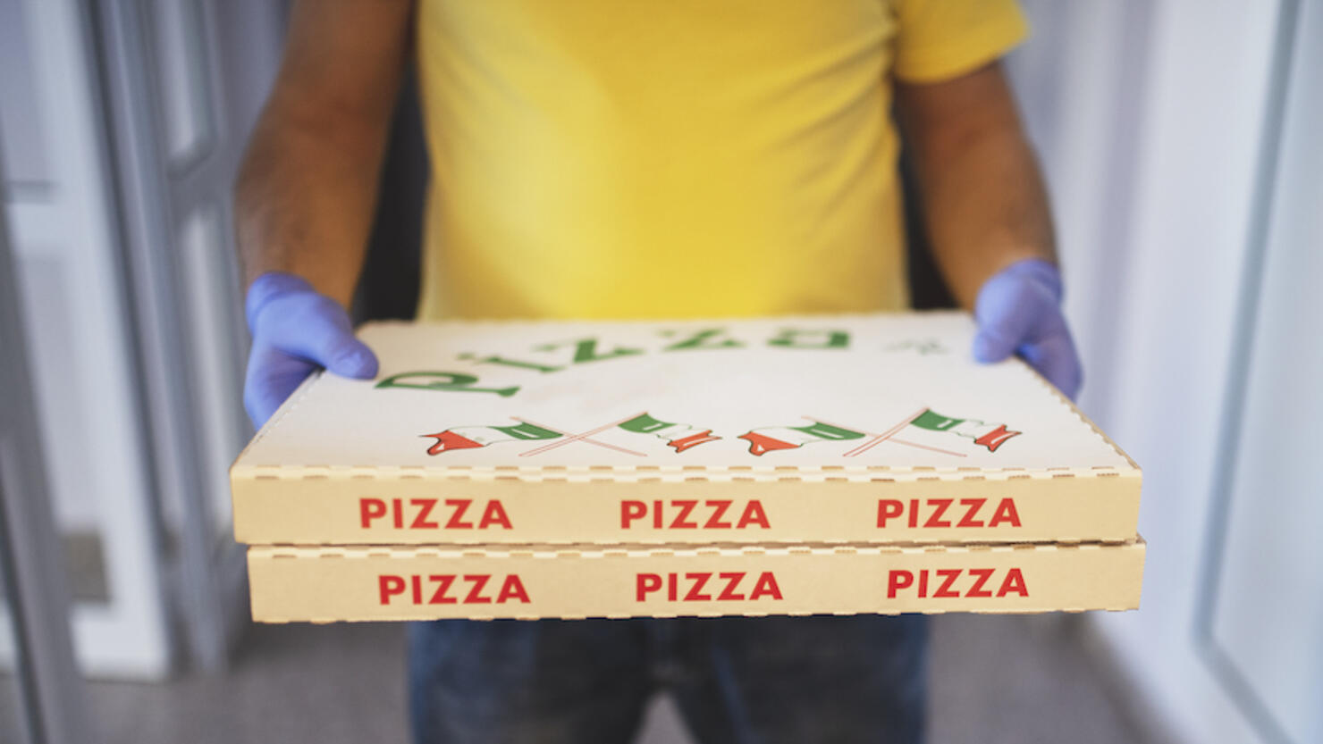 delivery of pizza with safety gloves