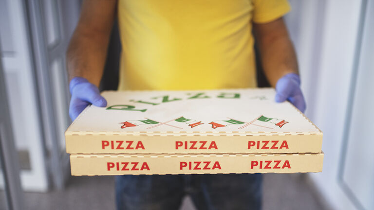 delivery of pizza with safety gloves
