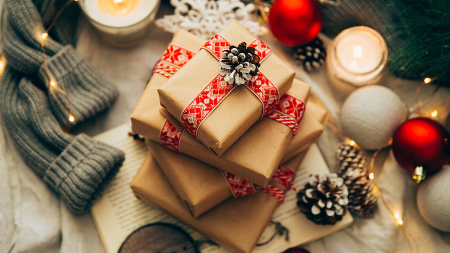 Stack of Christmas gifts, decorations and knitted sweater