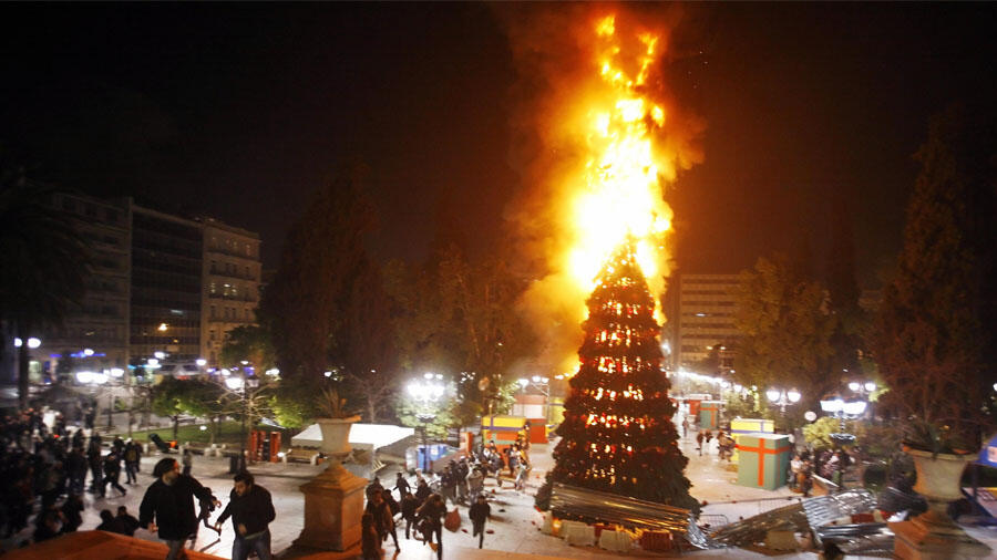 PHOTOS: 96-foot-tall Christmas tree goes up in flames outside hotel