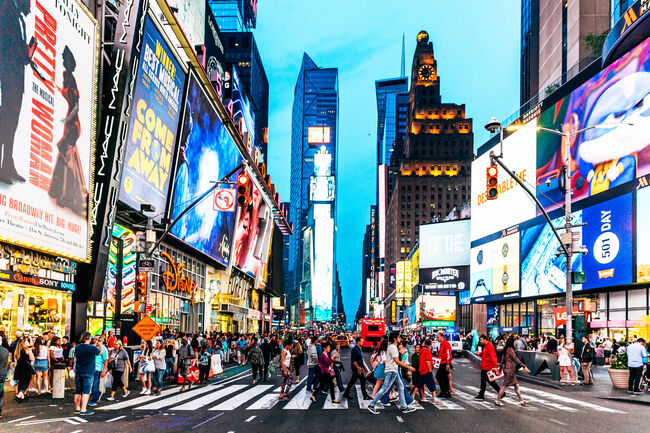 Crowds of people walking at Times Square at night, New York, USA