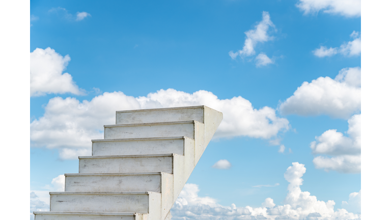 A white staircase to the sky with blue sky background.