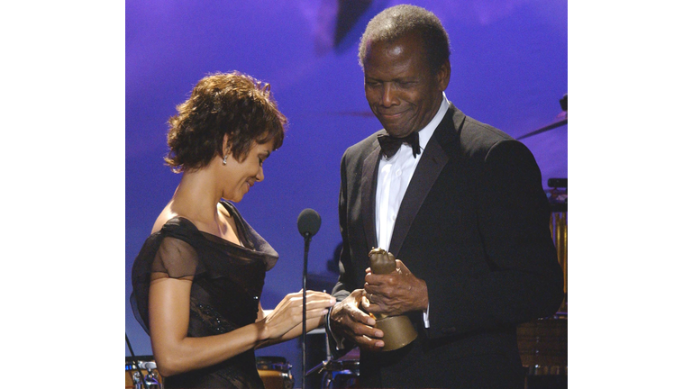 US actress Halle Berry (L) presents US actor Sidne