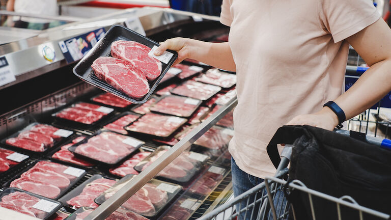 woman shopping at meat section