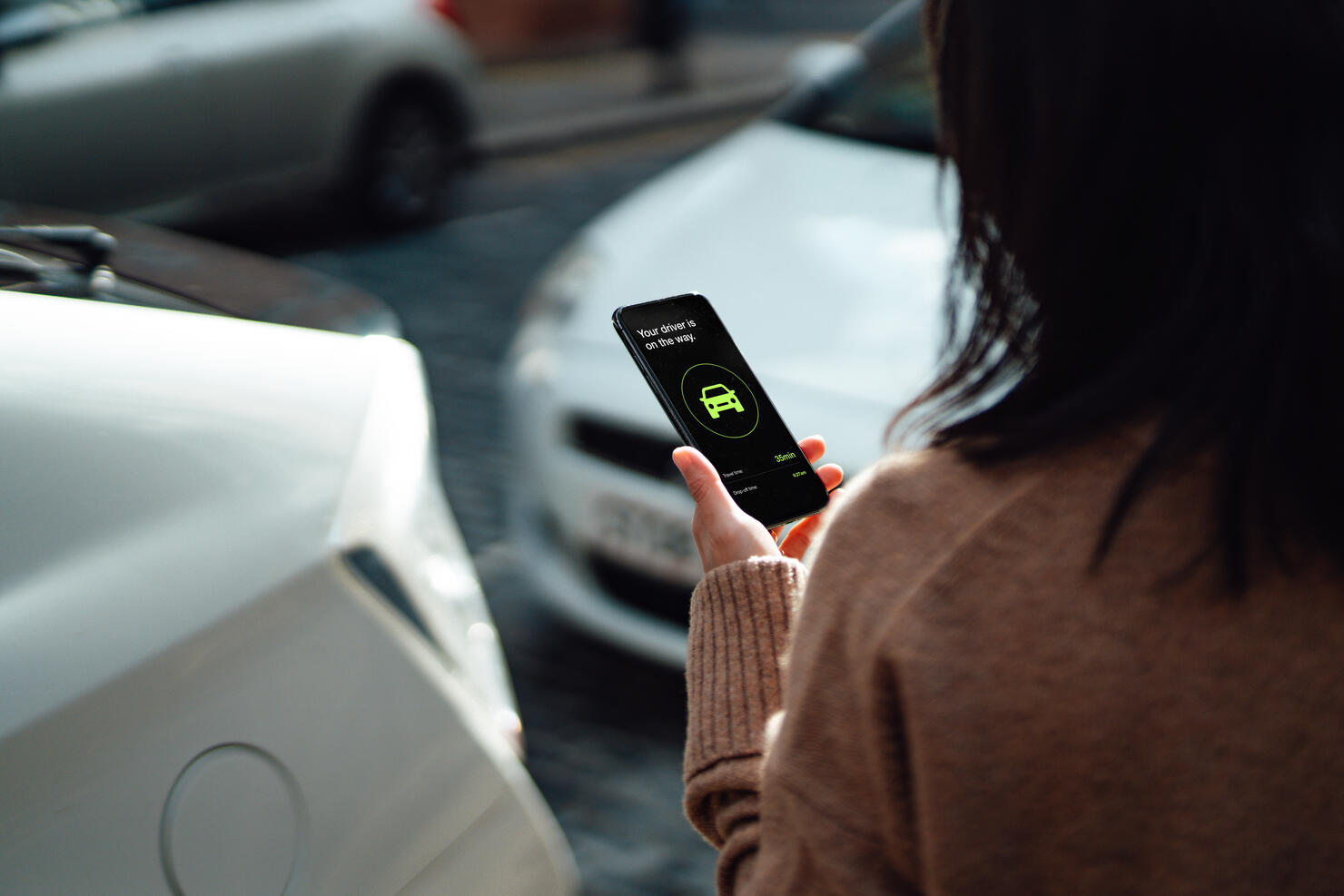 Young Woman Ordering Taxi Using Mobile App On Smartphone