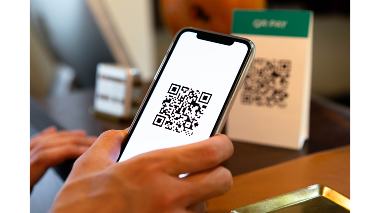 Men who use QR codes to make contactless payments using their smartphones