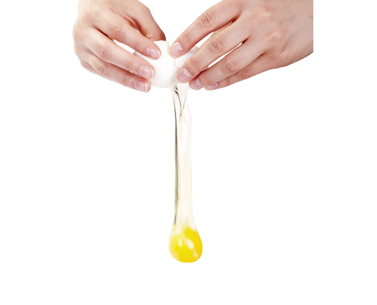 Close-up of hands cracking egg in midair isolated on white