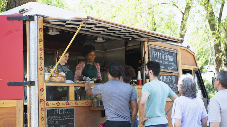 people making line to buy food from food truck