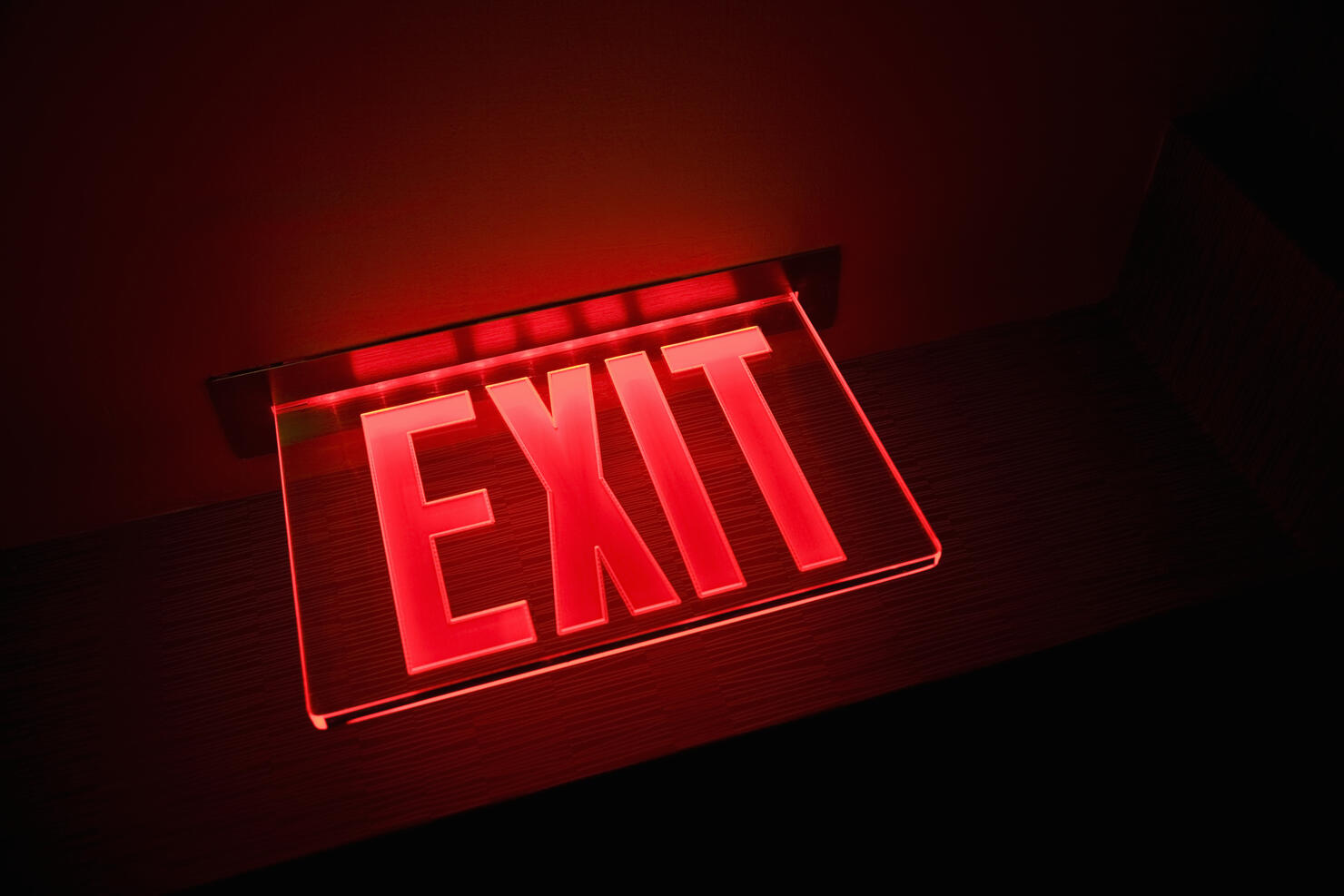 Exit sign illuminated, close-up, low angle view