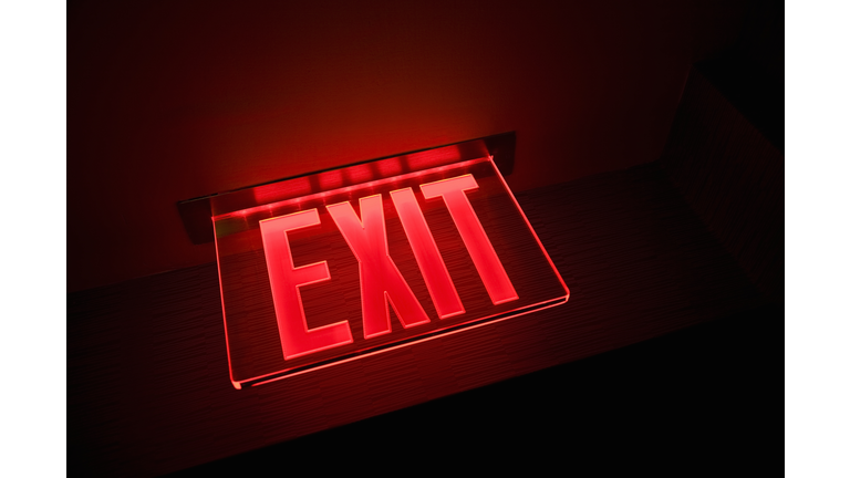 Exit sign illuminated, close-up, low angle view