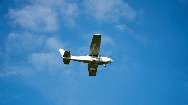 Small airplane isolated on blue, near the Cluj-Napoca. Transylvania, Romania.