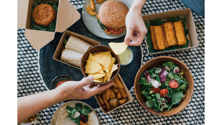Couple Sharing Takeaway Food At Home