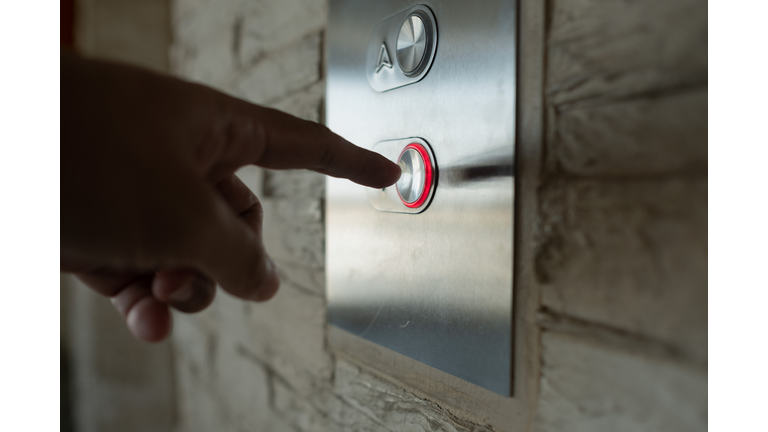 Close-Up Of Hand Holding Glass Door