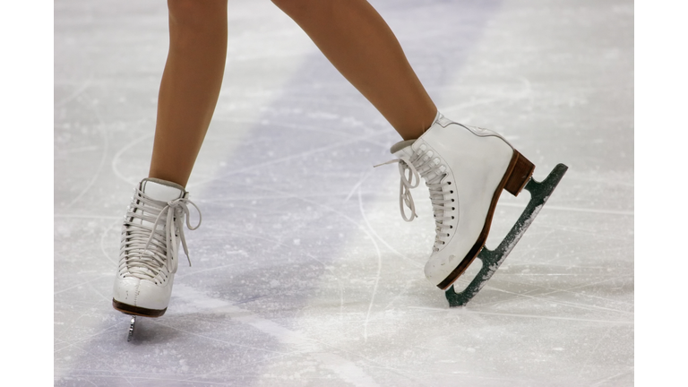 Close up of figure skaters feet in skates on ice