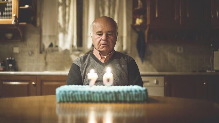Senior man celebrating alone his birthday
