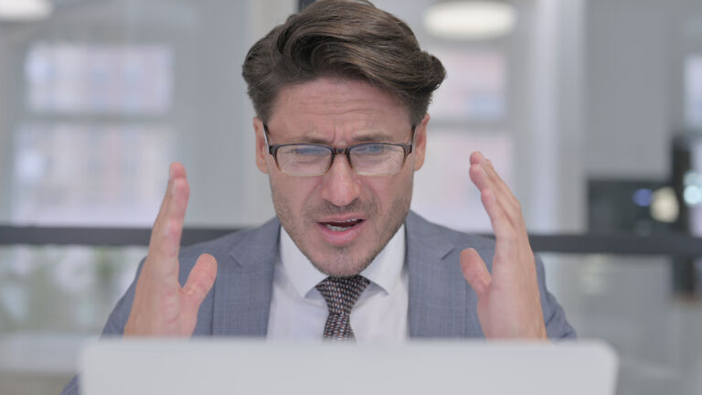 Portrait of Middle Aged Businessman having Loss on Laptop