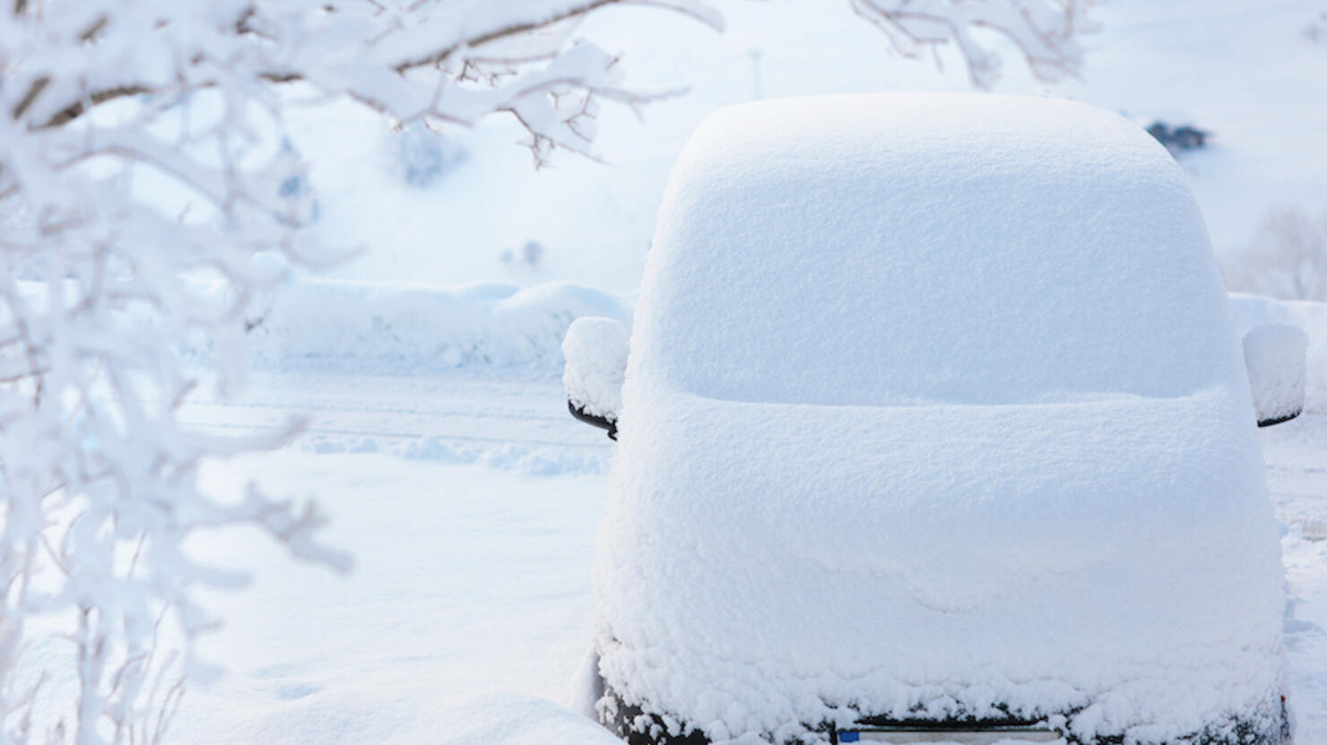 Car covered with snow after winter storm.
