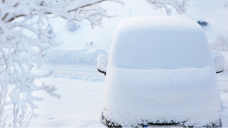 Car covered with snow after winter storm.