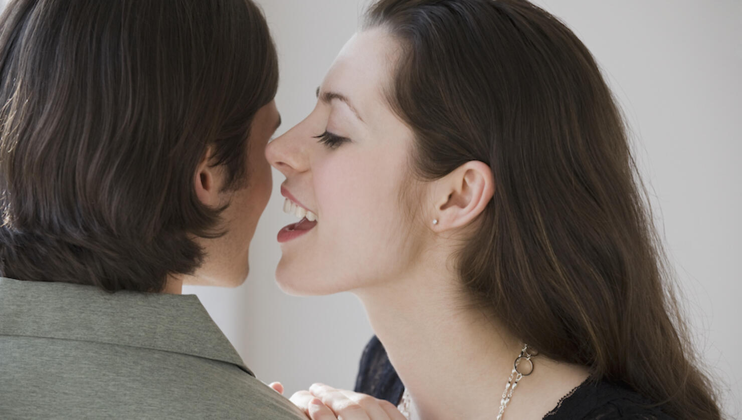 Woman whispering in boyfriend?s ear