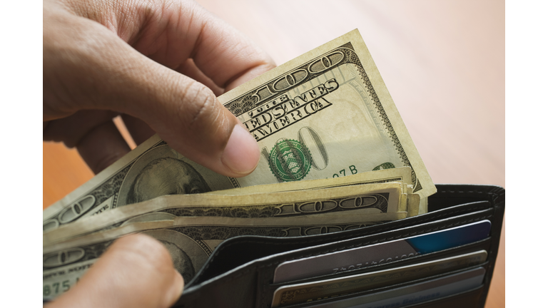 Mixed Race man taking money out of wallet