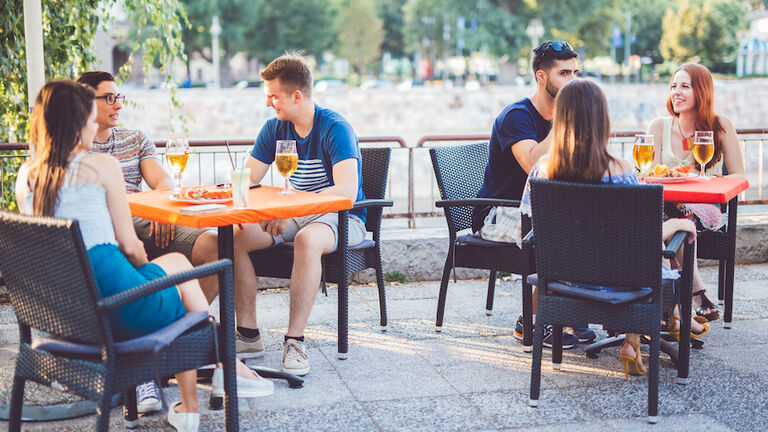 Young people relaxing in patio section