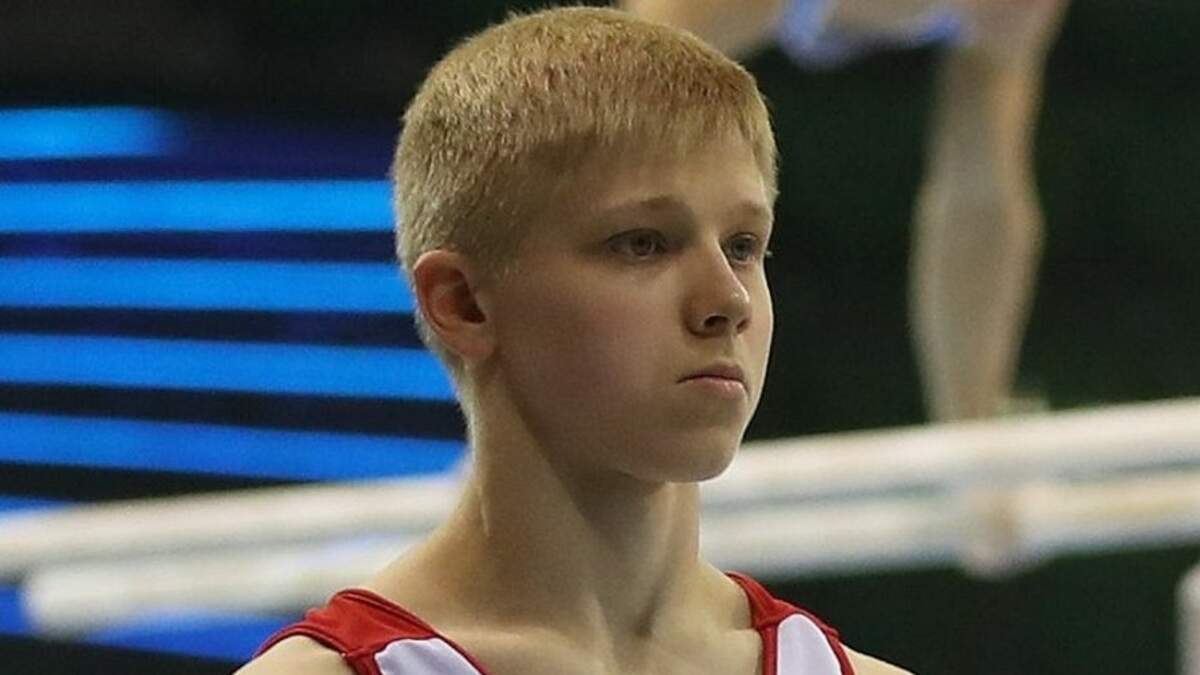 Russian gymnast stands on the podium with symbol supporting