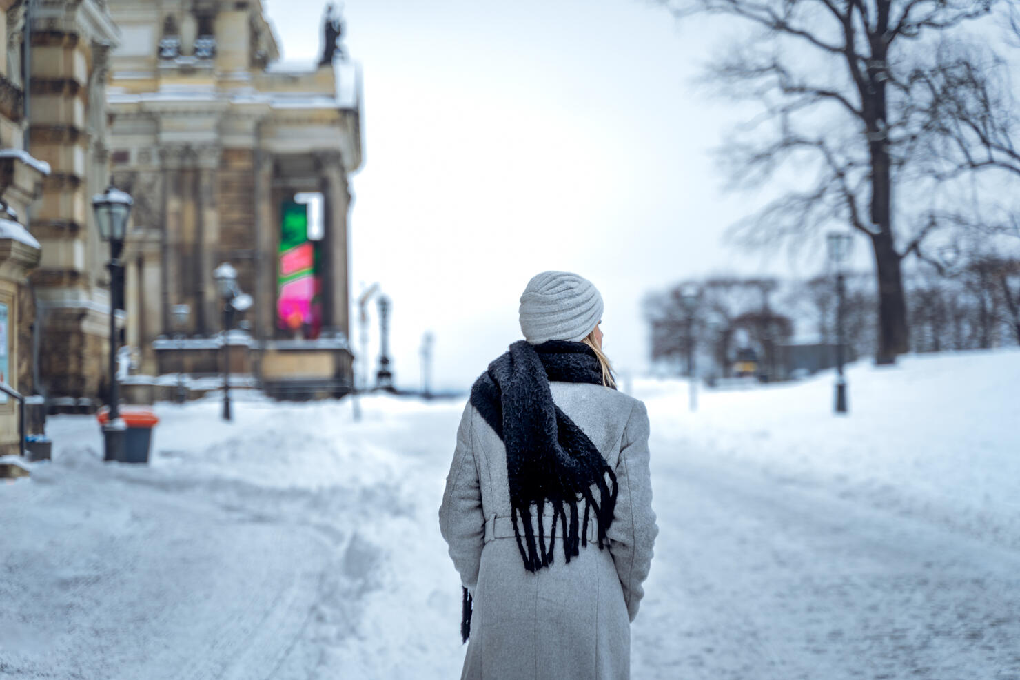 Woman walking on snowy street