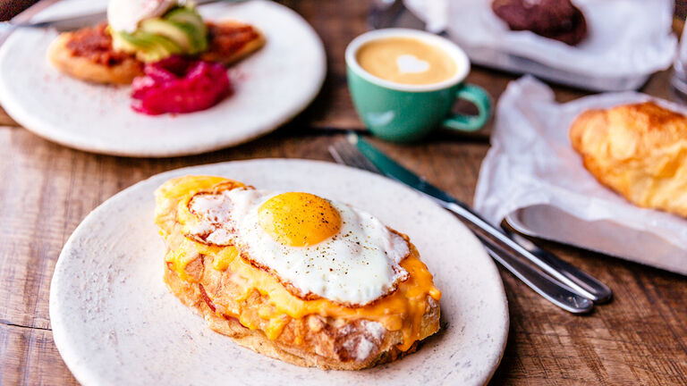 Close-up of croque madame with fried sunny side up egg on the table