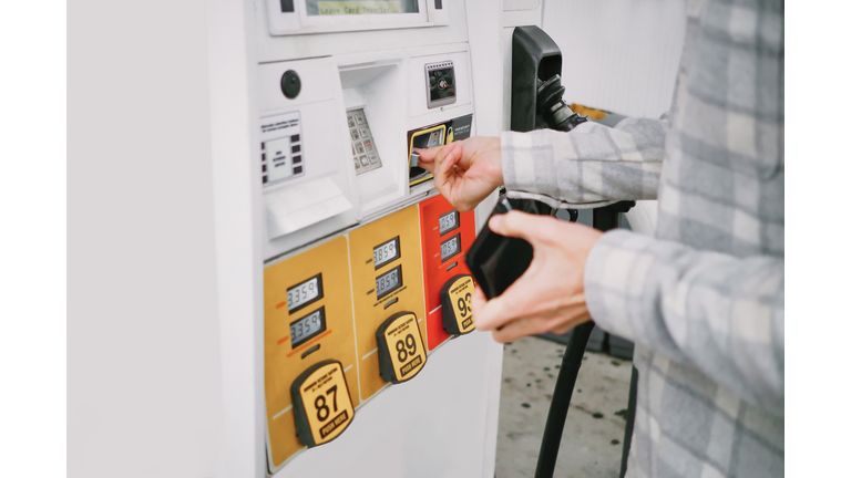 Man Purchases Gas at Pump