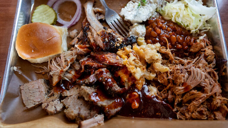 Above view of barbecue and sides on trays
