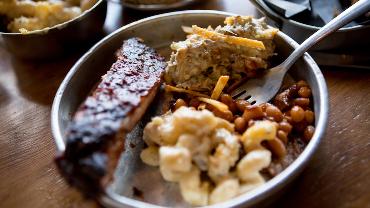 Variety of barbecue food with side dishes on table