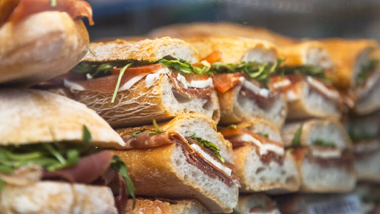 Panini made of arugula, tomato and prosciutto crudo