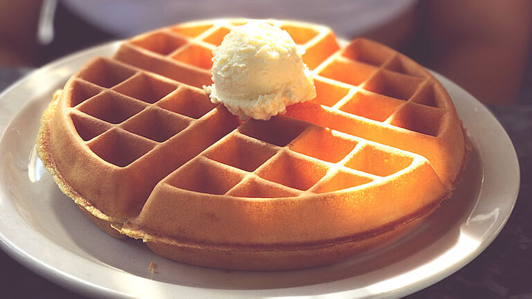 Midsection Of Woman With Ice Cream On Waffle In Plate