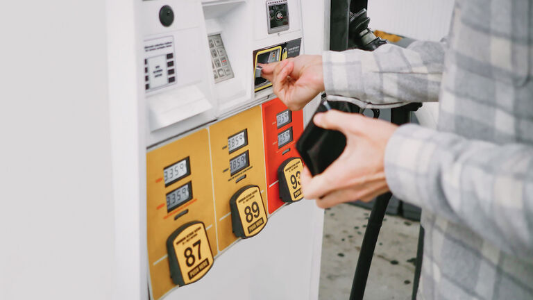 Man Purchases Gas at Pump