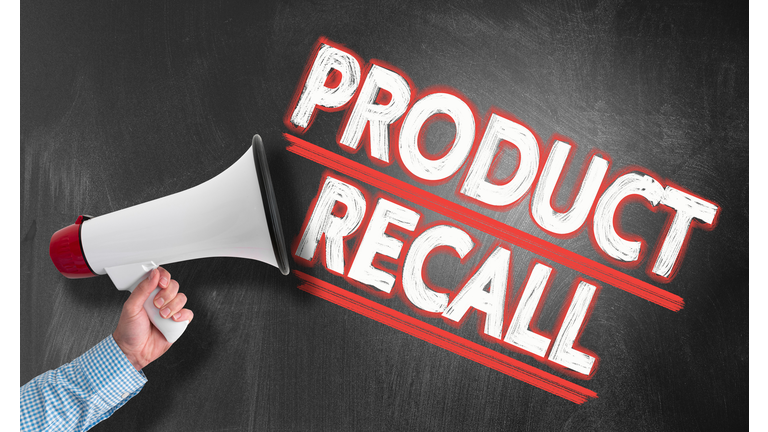 hand holding megaphone against blackboard with text PRODUCT RECALL