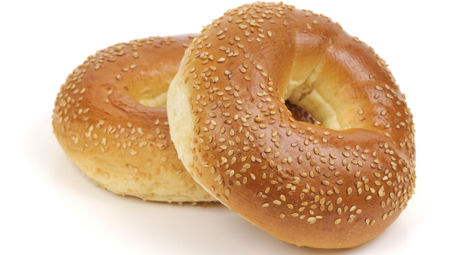 Two Sesame Seed bagels isolated on white background