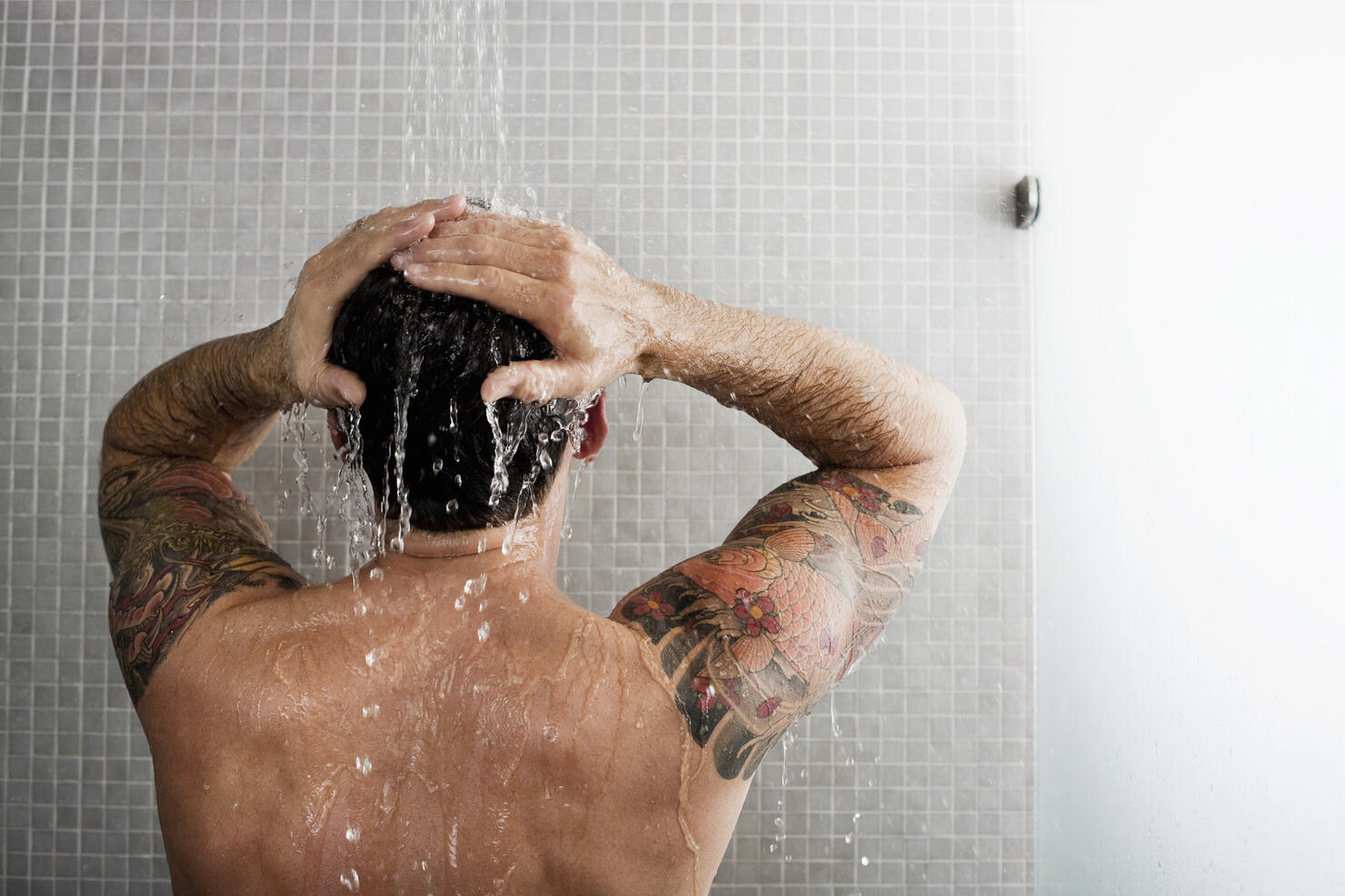 Man washing his hair in shower