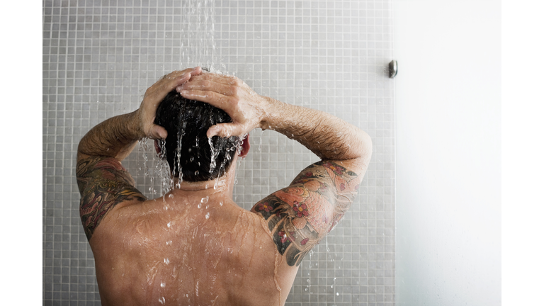 Man washing his hair in shower