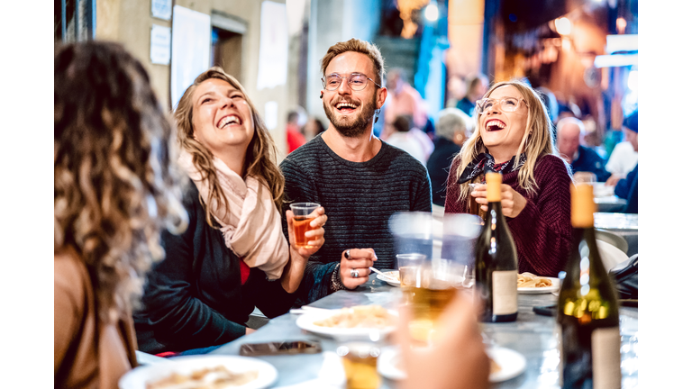Happy friends having fun drinking white wine at street food festival - Young people eating local plate at restaurant reopening together - Travel and dinning lifestyle concept on azur light neon filter
