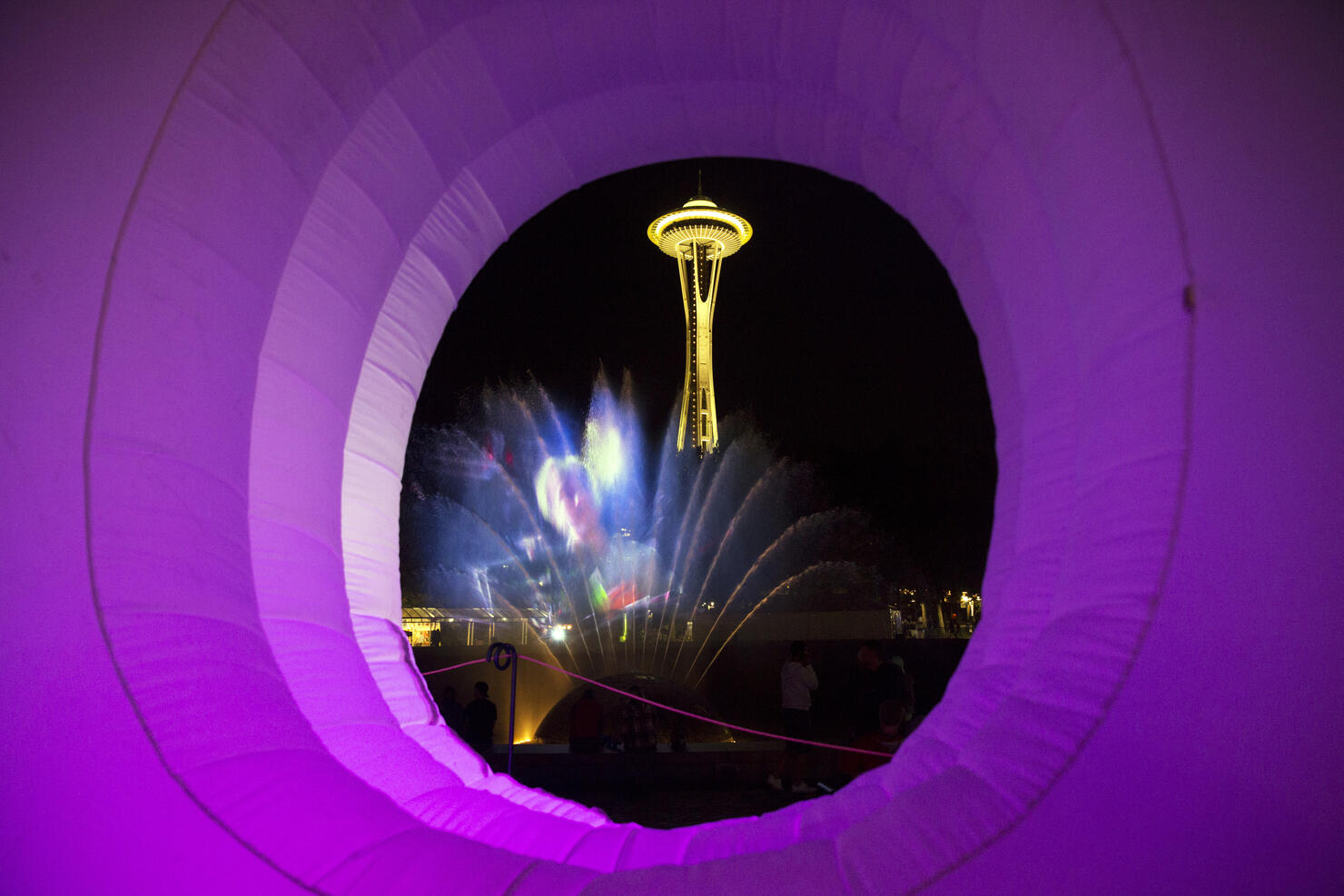The Space Needle and the International Fountain are seen through the O in an inflatable ""Bumbershoot"" on day two of Bumbershoot, Saturday, Sept. 3, 2016.  (Genna Martin, seattlepi.com)