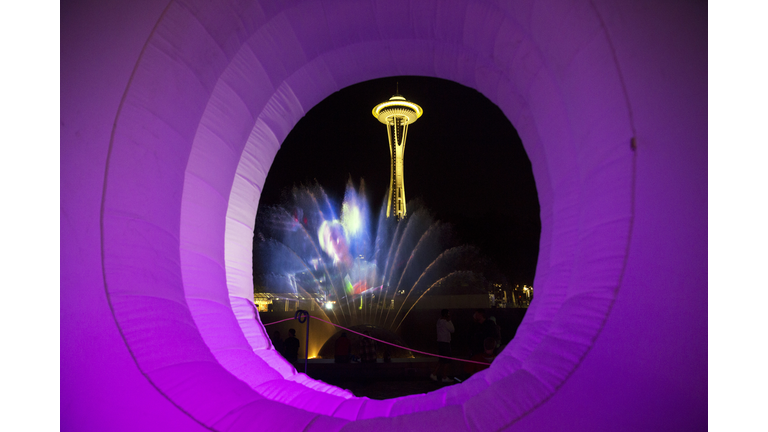 The Space Needle and the International Fountain are seen through the O in an inflatable ""Bumbershoot"" on day two of Bumbershoot, Saturday, Sept. 3, 2016.  (Genna Martin, seattlepi.com)
