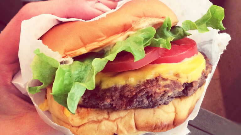 Close-Up Of Woman Holding Hamburger
