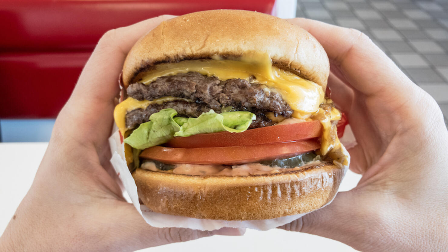 Close-Up Of Hand Holding Burger