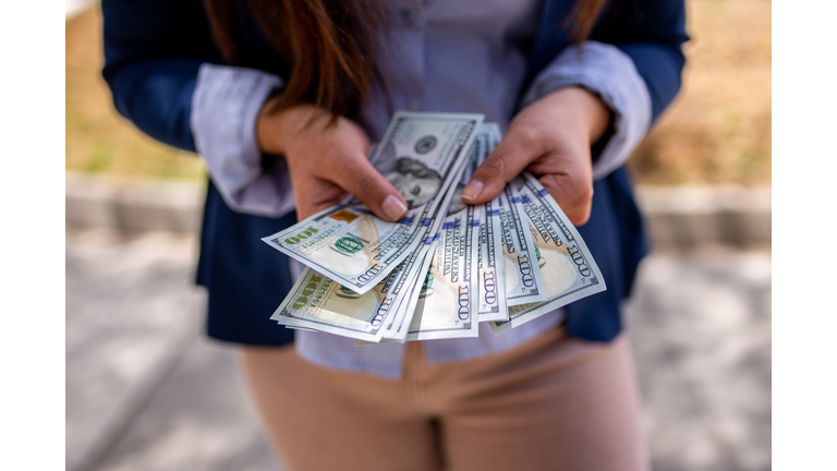 Midsection Of Woman Holding Banknotes